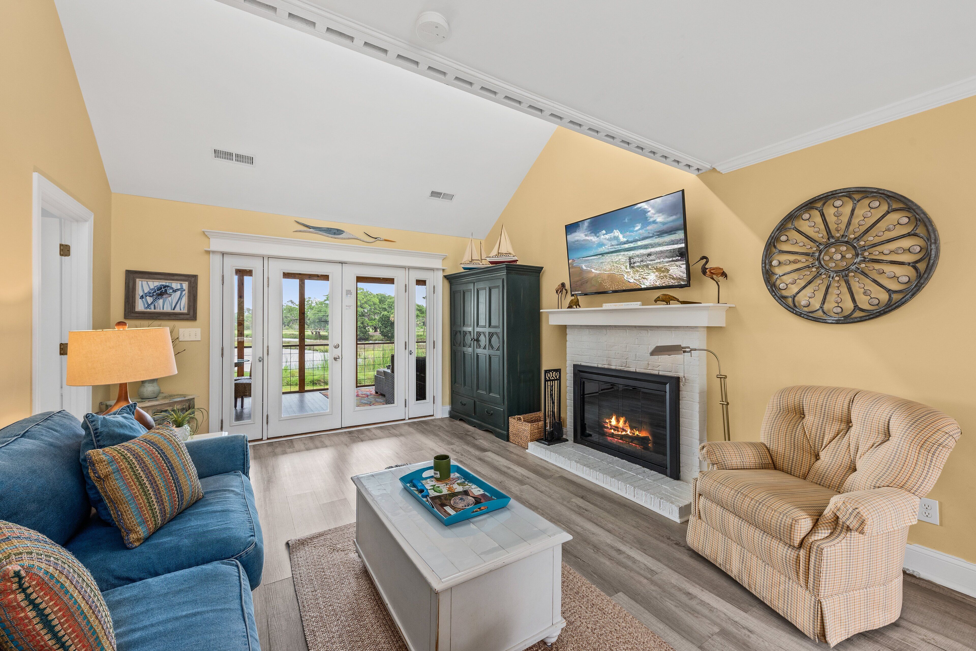 A living room with a fireplace, a sofa, a chair, and a coffee table.
