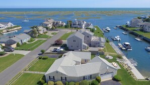 A coastal residential area with houses, a marina, and boats. - "Sea Gypsy"  Waterfront newly renovated, beautiful views, dock, beach! (Dennis)