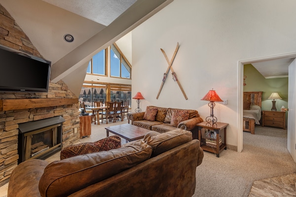 Living area with queen sleeper sofa, flat screen TV and gas fireplace
