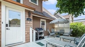 A house with a porch, a grill, and outdoor seating. - 4 Beds, 4 bathrooms! 1 block to town shops, bars, bowling, canoeing, and parks! (Flushing)