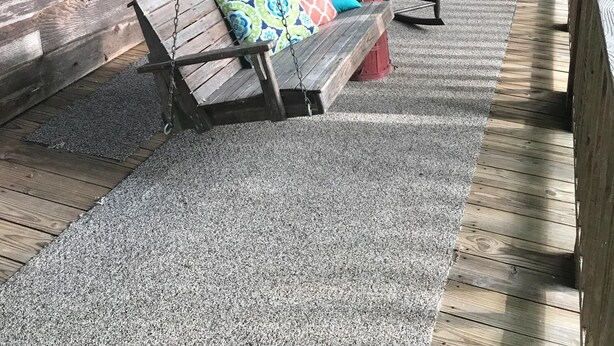 A wooden porch with two swing seats, each with colorful cushions, and a wooden deck with a railing. - Quiet Rustic Getaway (Whittier)