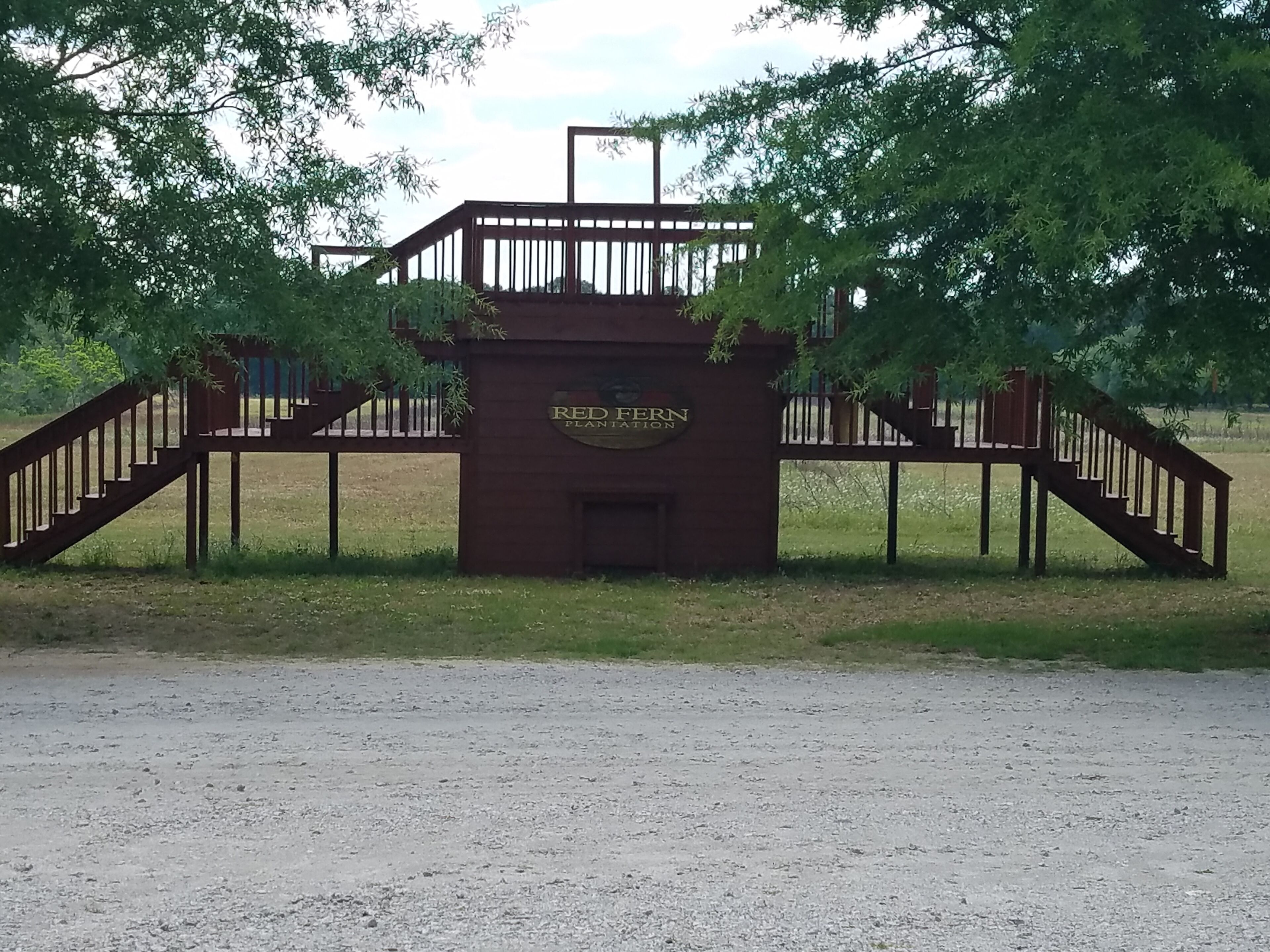 A gated entrance with a sign reading "RED FERN PLANTATION".
