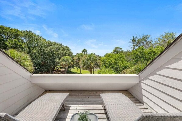 A rooftop terrace with a view of a lush garden and trees. - Great Location! Walk to Beach, Club, Golf, Pools! Distant Ocean Views! Amenity access included! (Seabrook Island)