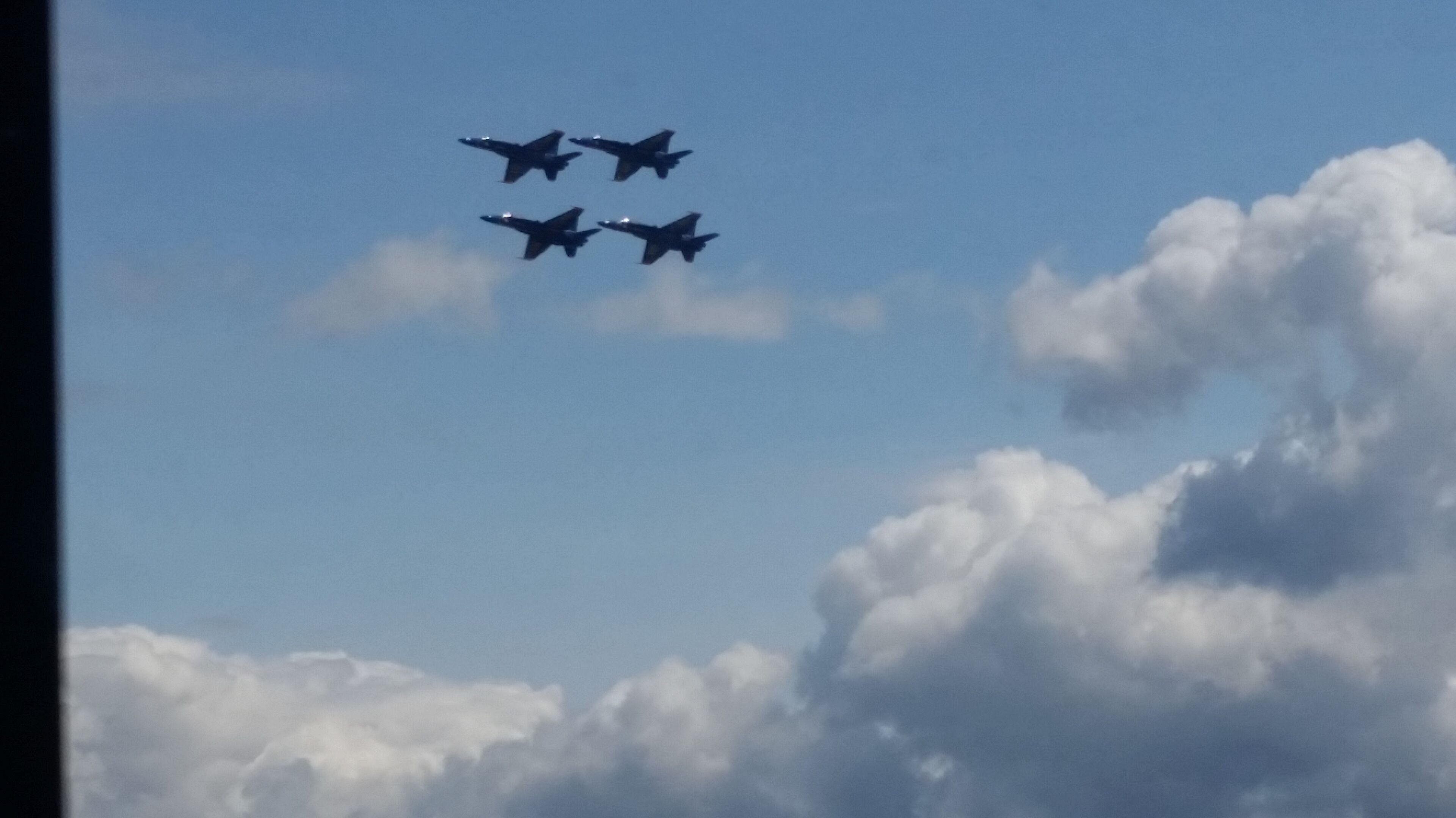 Three airplanes flying in formation against a backdrop of clouds.