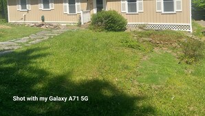 A single-story house with a front porch, a chimney, and a number '102' on the door. - Lake front property with one dock space for boat/jet ski on Lake Wallenpaupack. (Greentown)
