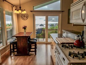 Enjoy ocean views from the kitchen window, where you can cook and dine with a central island and bar stools.