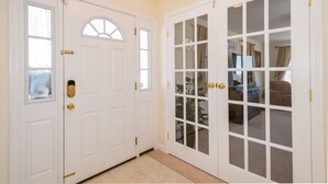 A white door with a window and a keypad lock.