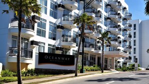 A multi-story hotel with balconies, a sign reading "OCEANWAY RESIDENCES 1", and palm trees. - Gerbi's Condoplace at Oceanway Residences Boracay (Boracay Island)