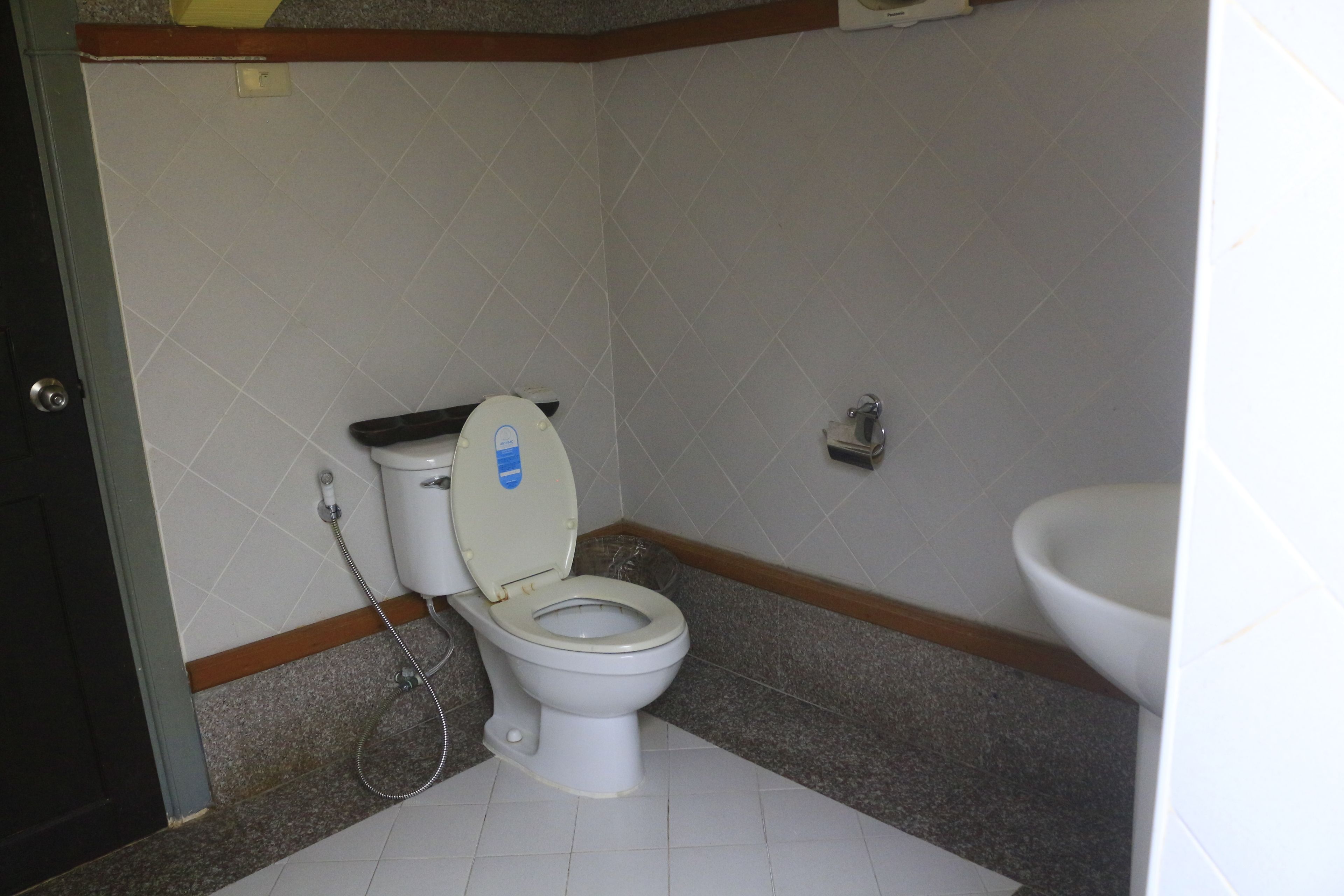 A small bathroom with a toilet, a bidet, and a sink.