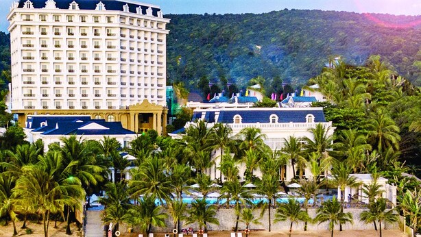 A beachfront hotel with multiple floors, a pool area, and palm trees. - Thien Thanh Resort Phu Quoc (Phu Quoc)