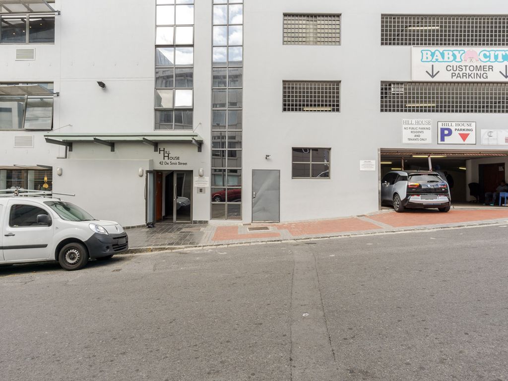 A building with a 'Hill House' sign, a 'Baby City' sign, and a 'Hill House Parking' sign.