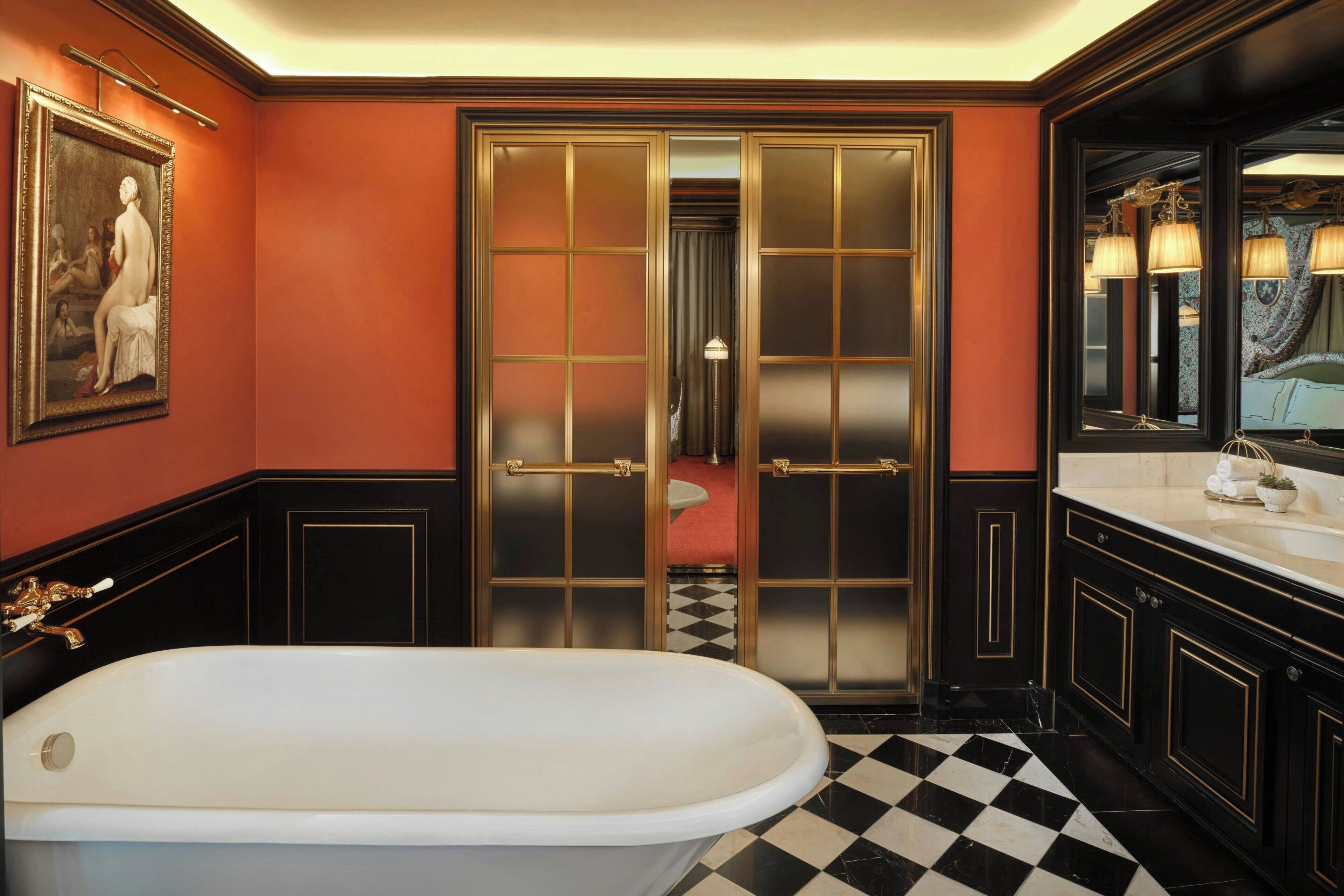 A bathroom with a white bathtub, a large mirror, and a checkered floor.