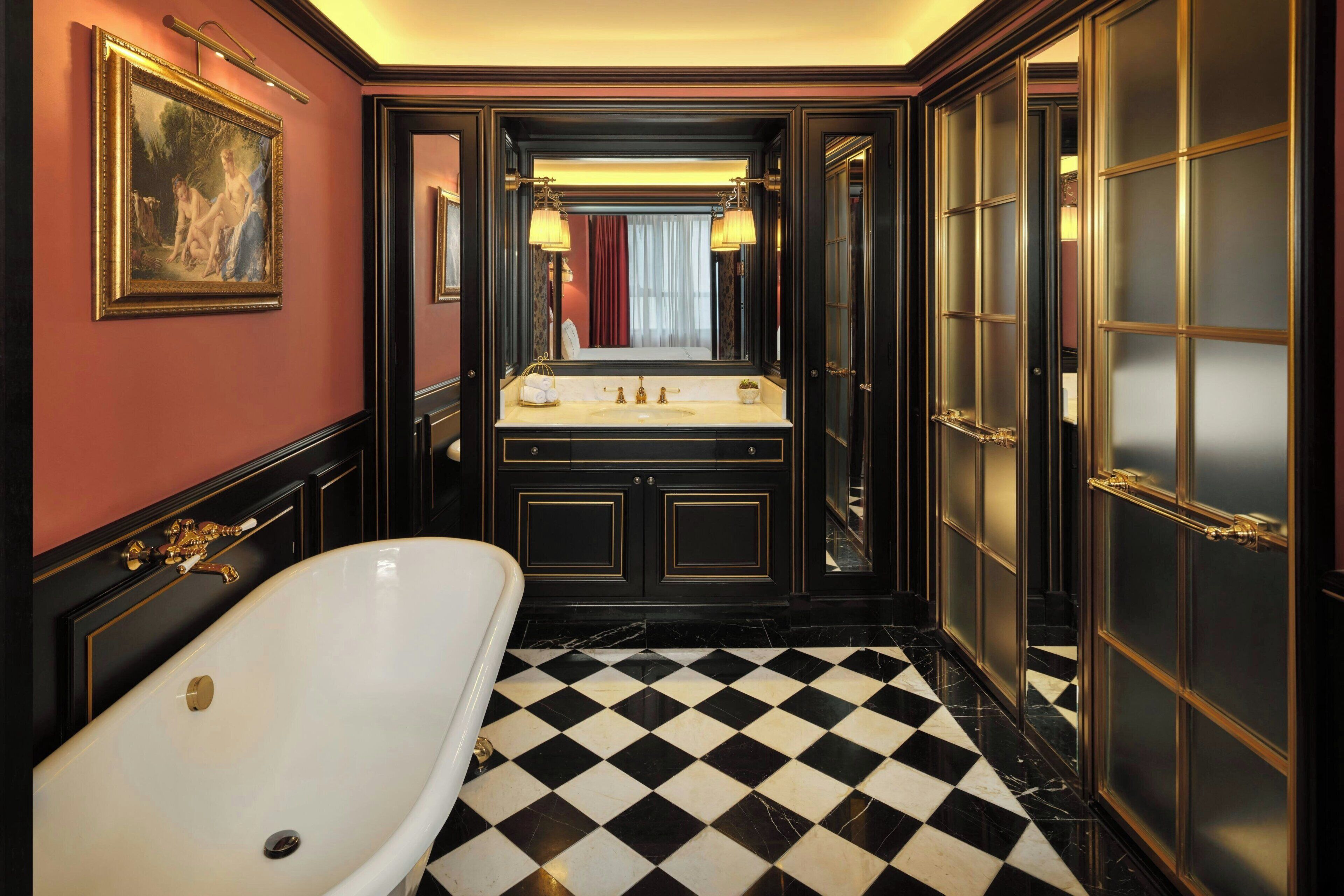 A luxurious bathroom with a large bathtub, a vanity with a mirror, and a checkered floor.