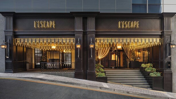 A hotel entrance with 'L'ESCAPE' signage, a grand staircase, and decorative lighting. - L’Escape, a Luxury Collection Hotel, Seoul Myeongdong (Seoul)