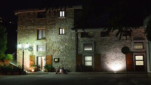 Un bâtiment en pierre doté de nombreuses fenêtres et d’une entrée bien éclairée.
