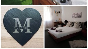 A hot tub with controls, a wooden chair, and a window with greenery outside. - Le Clos des Mylandes (Dax)