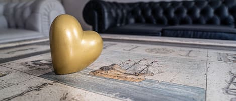 A heart-shaped object on a tiled floor with a ship illustration.
