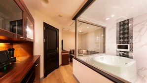A modern bathroom with a large bathtub, a wooden vanity, and a glass-enclosed shower area. - i RESORT ARTIA Luxury GIFU - Adult only (Gifu)