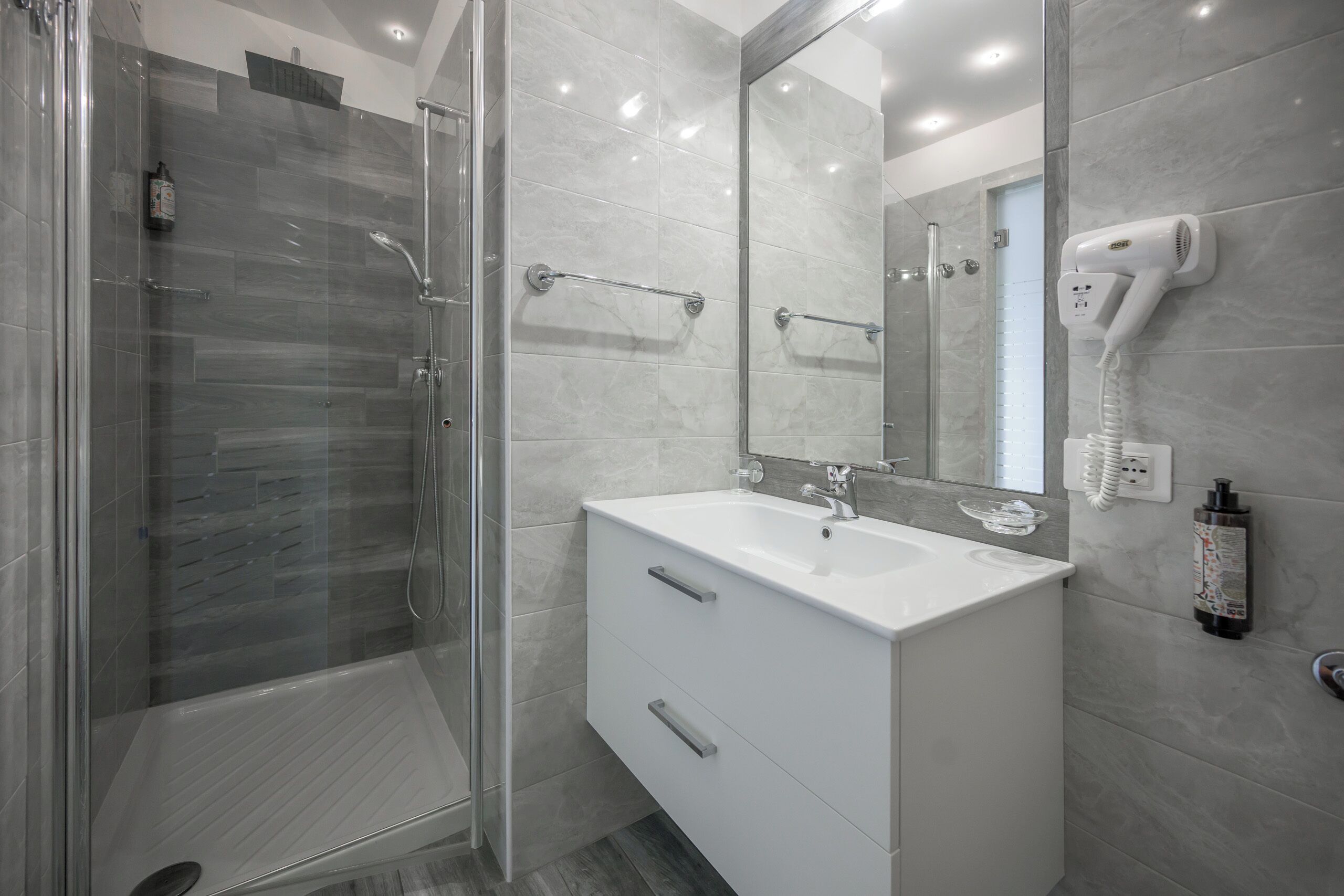 superior room | bathroom | shower, hair dryer, towels, soap