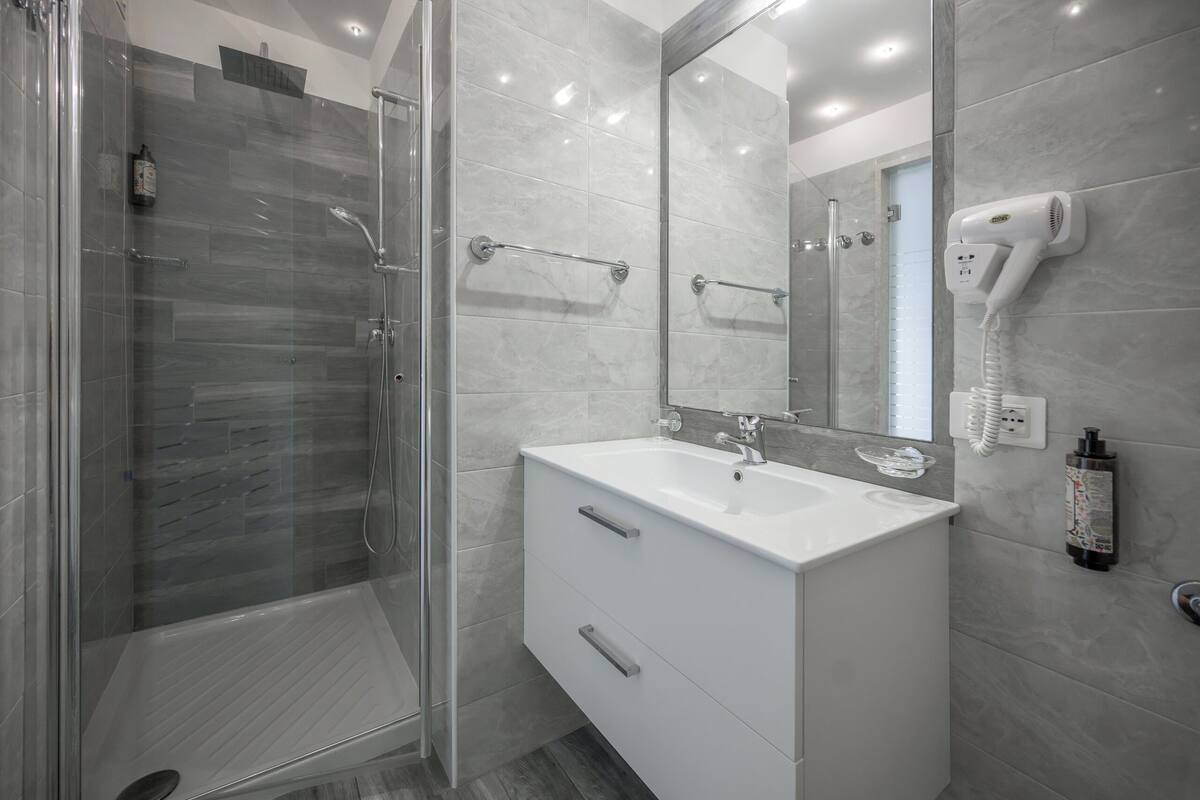superior room | bathroom | shower, hair dryer, towels, soap