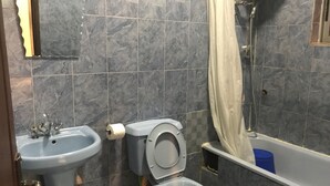 A bathroom with a toilet, sink, and bathtub. - Bayview Resorts and Hotels (Enugu)