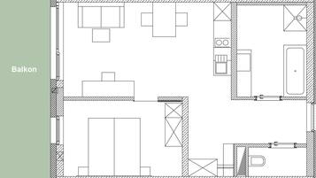 A floor plan of a building with a balcony area, a kitchen, a bathroom, and a living area.