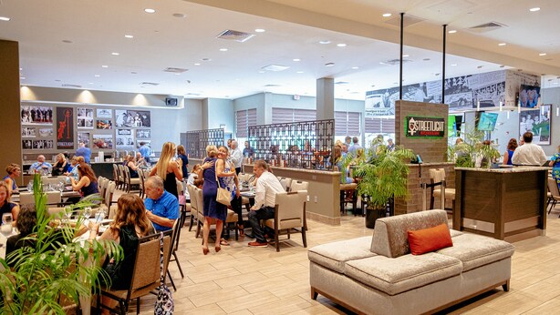 A spacious restaurant with multiple dining areas, a bar, and a kitchenette. - Holiday Inn & Suites Philadelphia W - Drexel Hill by IHG (Drexel Hill)