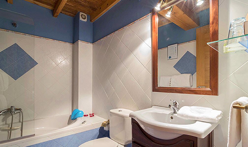 A bathroom with a bathtub, a sink, and a mirror.