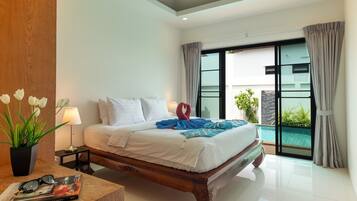 A modern hotel room with a large bed, a bedside table with a lamp, a potted plant, and a view of an outdoor swimming pool.