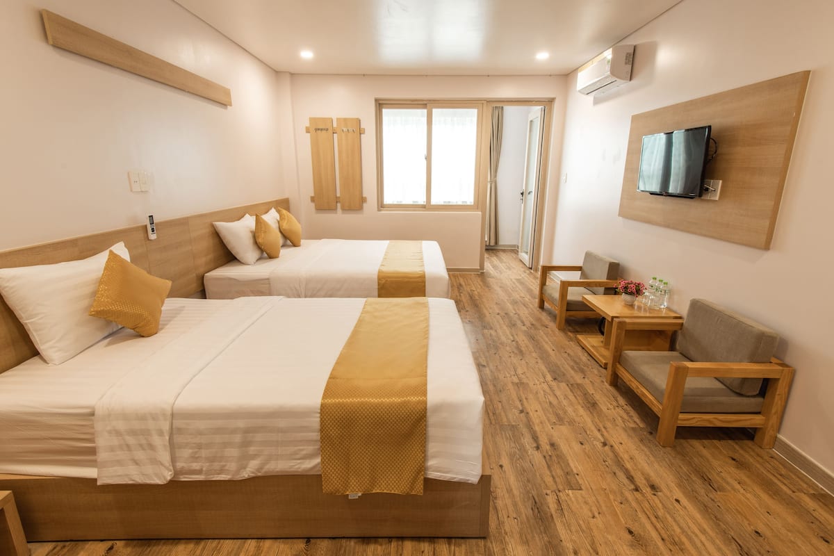 Deluxe Triple Room, Balcony, City View | Minibar, in-room safe, desk, blackout drapes