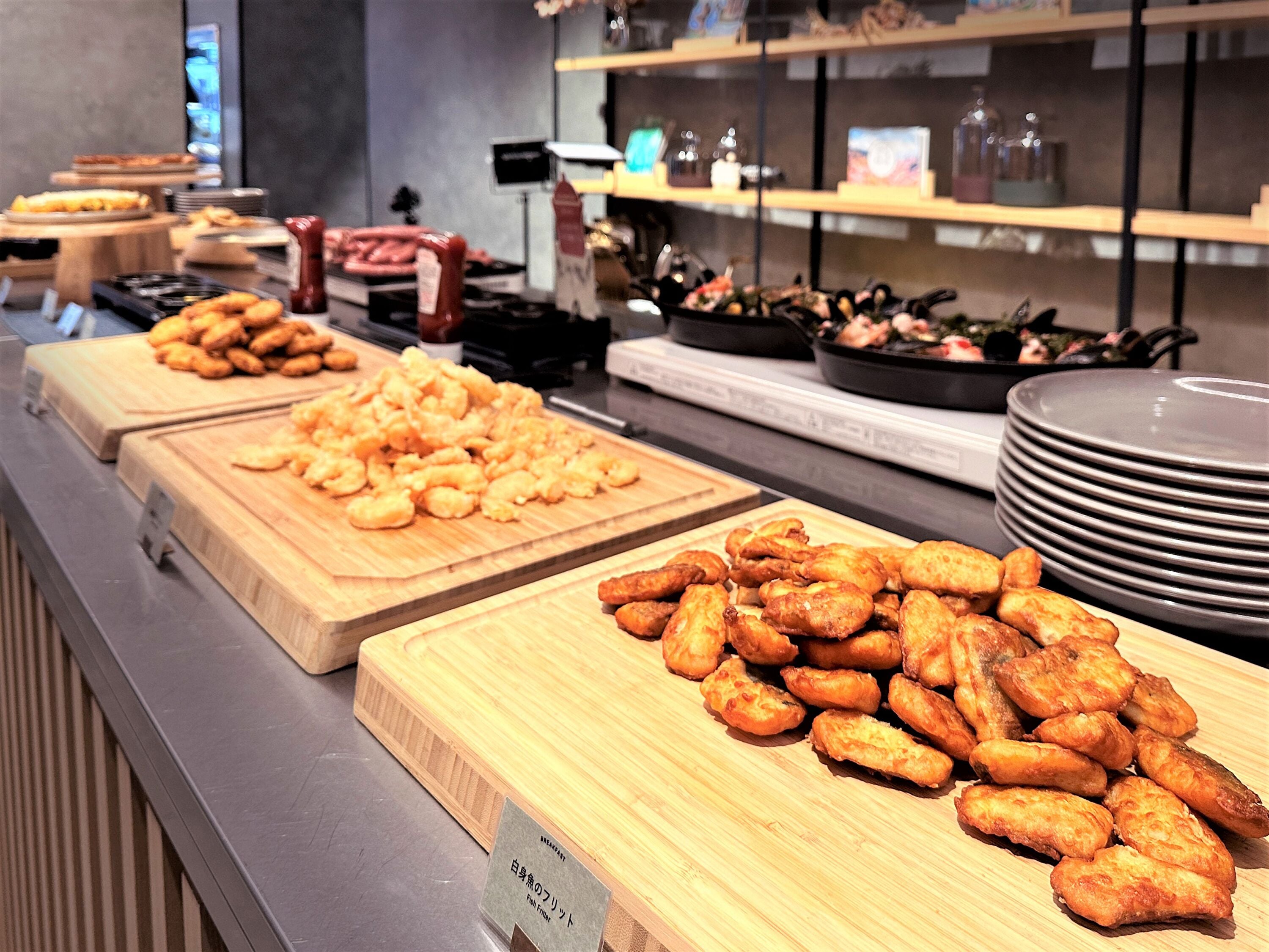 A buffet with various food items including fried fish and other dishes.