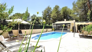 A swimming pool with lounge chairs, a covered seating area, and a building with a tiled roof. - Villa CA NA CARMEN with garden, private pool in Crestatx and very close to POLLENÇA. Quiet zone. - Free Wifi (Sa Pobla)