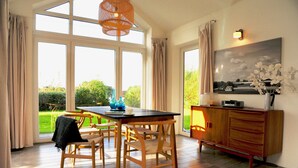 A dining area with a table, chairs, and a cabinet. - Schlei Resort Marina sleeves (Kosel)