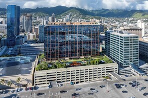A multi-story parking garage with a modern building in the foreground.