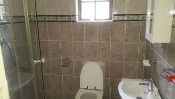 Deep-soaking bathtub, rainfall showerhead, free toiletries, bathrobes