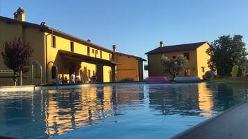 Seasonal outdoor pool, open 9:00 AM to 8:00 PM, pool umbrellas
