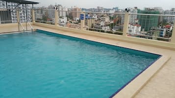 Enjoy a serene swim with a clear view of the surrounding cityscape from our rooftop pool.