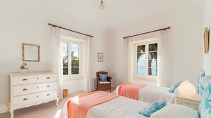A bedroom with two beds, a dresser, a chair, and a nightstand. - Quinta D'Alegria by Our Madeira (Funchal)