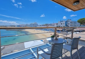 A balcony with a view of a beach and buildings. - Hotel Boutique La Marquesina Adults Only (La Oliva)