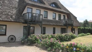 A traditional building with a thatched roof, two balconies, and a paved driveway. - Kur- & Landhotel Borstel-Treff (Dabel)
