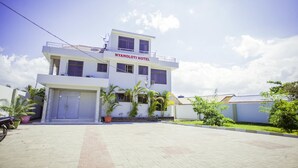 A two-story hotel with a flat roof and a sign reading "NYAHOLOTI HOTEL". - Nyaholoti Airport Hotel (Dar es Salaam)