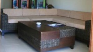 A living room with a beige sectional sofa, a dark wooden coffee table, and a low ceiling. - Apartment/ flat - Koh samui (Koh Samui)