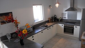 A modern kitchen with a built-in oven, a sink, and a window with blinds. - 3-STAR FISHERMAN'S STYLE HOUSE IN CANCALE 300M FROM THE PORT QUIET AREA (Cancale)