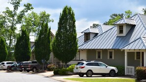 A residential street with houses, parked cars, and trees. - BOLTON COVE: 10 Cricket Ln. Pool, beach, playground, boat rental - 4 homes avail (Lake Martin)