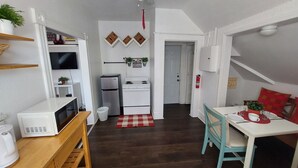 A compact kitchen with white appliances, a ceiling fan, and a red checkered rug. - Dream holiday at a low price: huge travel discounts now available! (Fort Myers)
