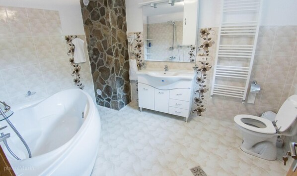 A bathroom with a bathtub, a sink, and a toilet.