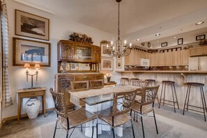 Enjoy cooking in this well-appointed kitchen with a central island, chandelier, and wooden cabinetry.