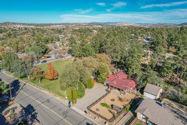 An aerial view of a residential area with houses, roads, and a clear sky.