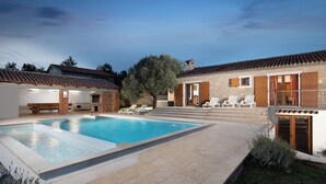 A swimming pool with lounge chairs, a brick building with a tiled roof, and a stone pathway. - LUX CASA HISTRIA I - with heated swimming pool & jacuzzi (Pazin)