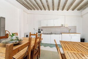 Enjoy cooking in this kitchen with a microwave, sink, and dining table.